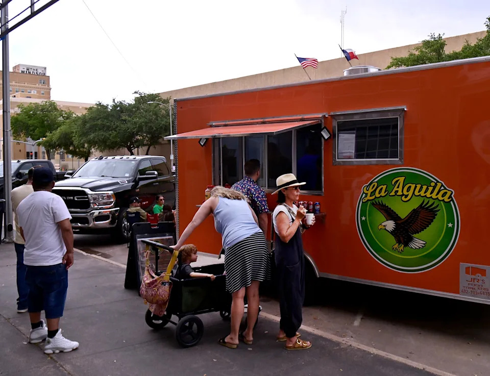 Spectators buy treats at a food truck before the start of the Cinco de Mayo Parade in Abilene Tuesday May 5, 2026. This was the first parade that returned to the traditional route utilizing Cypress Street after the downtown renovation of the entire corridor.