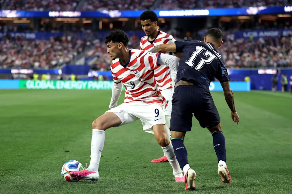 Ricardo Pepi #9 of the United States is challenged by Alejandro Romero Gamarra #17 of Paraguay during the FIFA World Cup 2026 Group D match between USA and Paraguay at Los Angeles Stadium on June 12, 2026 in Los Angeles, California.