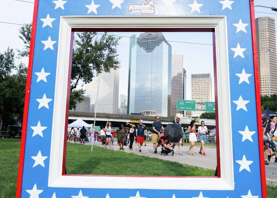 Festival goers make their way down Allen Parkway during the annual Freedom Over Texas at Eleanor Tinsley Park on the Fourth of July, Thursday, July 4, 2024, in Houston. (Jason Fochtman/Staff photographer)