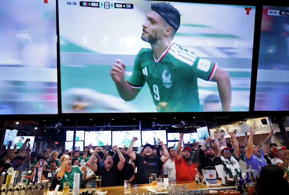 Mexico soccer fans sitting at the Ojos Locos bar celebrate Raúl Jiménez (on screen) second goal against South Africa during the opening FIFA World Cup game. The watch party was held in Dallas, June 11, 2026. (Tom Fox/The Dallas Morning News)