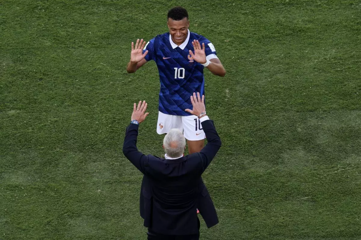 France head coach Didier Deschamps and Kylian Mbappe celebrate after the third goal during the World Cup Group I soccer match between France and Senegal in East Rutherford, N.J., near New York, Tuesday, June 16, 2026. (AP Photo/Adam Hunger)