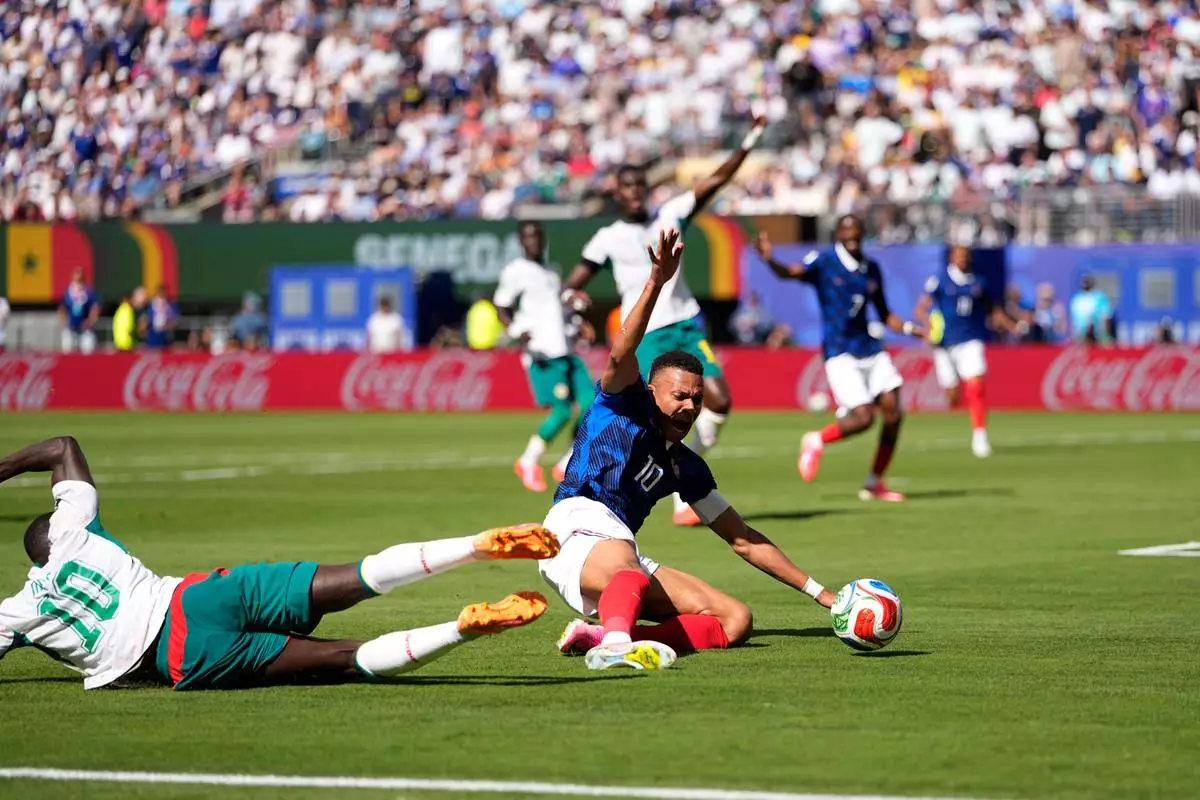 Senegal's Sadio Mane, left, stops France's Kylian Mbappe during the World Cup Group I soccer match between France and Senegal in East Rutherford, N.J., near New York, Tuesday, June 16, 2026. (AP Photo/Frank Franklin II)