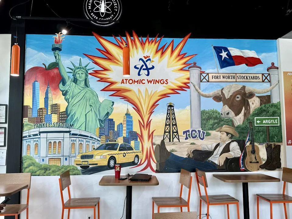 A mural at the Atomic Wings location in Fort Worth features images of New York, Fort Worth, TCU and actor James Dean from the poster for the movie “Giant.”