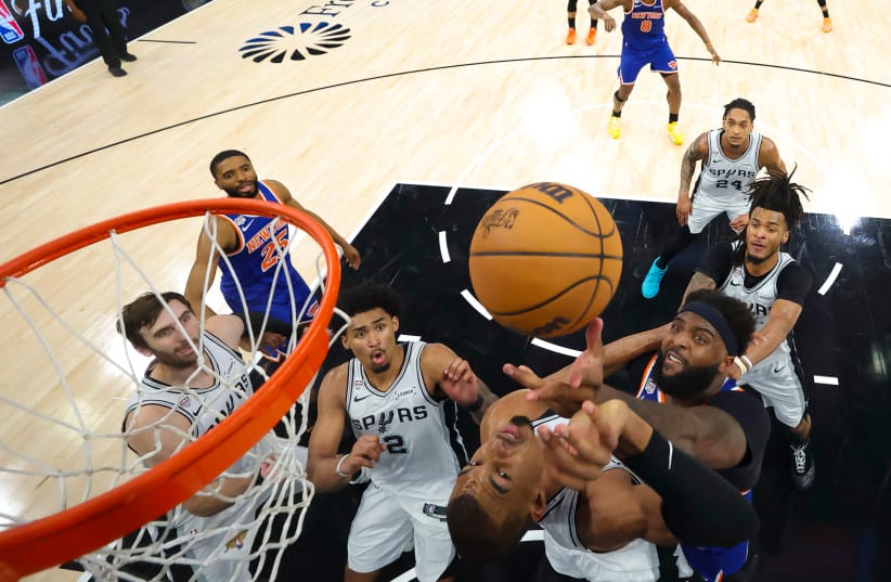 Jun 13, 2026; San Antonio, Texas, USA; New York Knicks center Mitchell Robinson (23) and San Antonio Spurs forward Victor Wembanyama (1) battle for the ball during game five of the 2026 NBA Finals at Frost Bank Center.