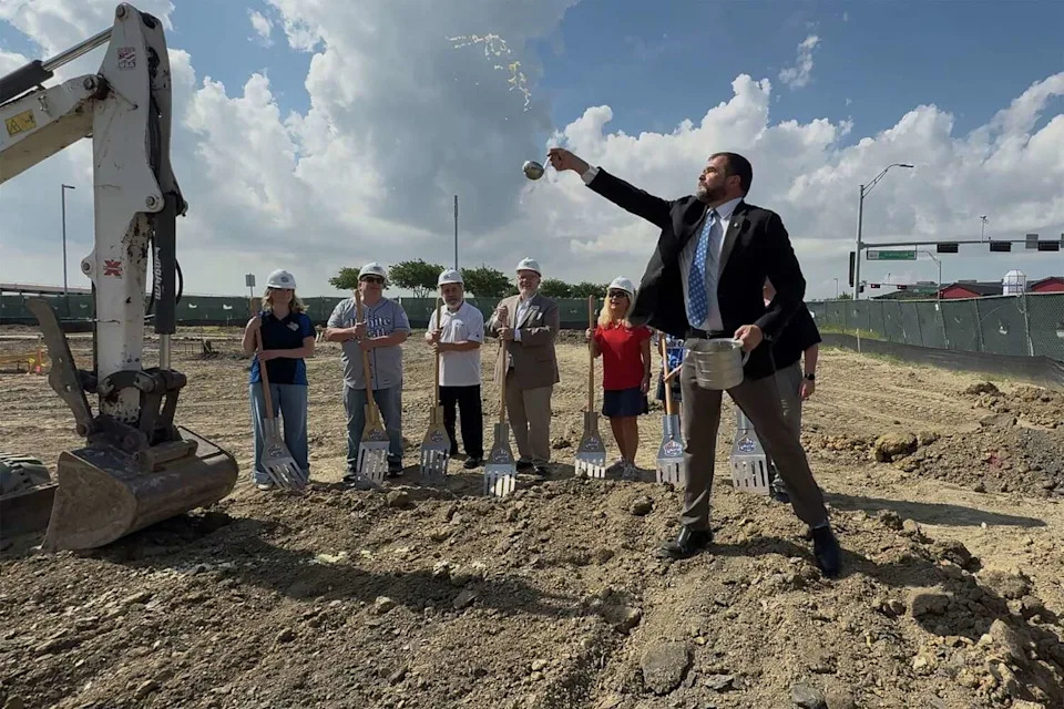 Chief Marketing Officer Jamie Richardson sprinkles the ground with onions during a groundbreaking ceremony for a White Castle in The Colony on June 2, 2026. (Chitose Suzuki/The Dallas Morning News)