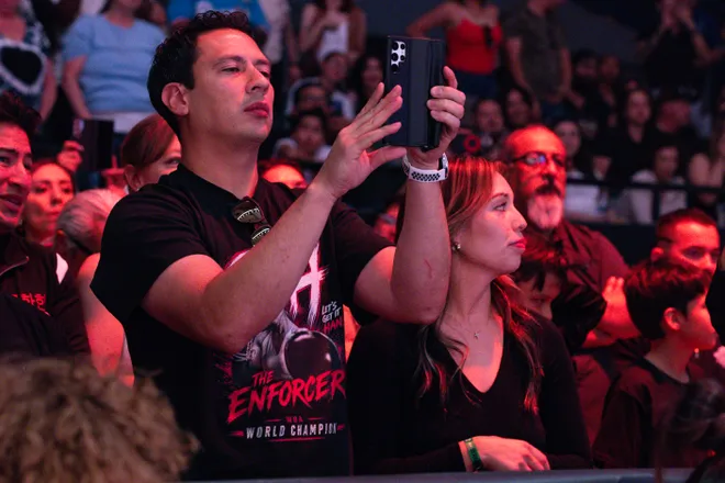 Stephanie Han's husband, Abner Garcia, records video before Han's WBA lightweight world championship bout against Albuquerque boxer Holly Holm Saturday, May 30, 2026, at the El Paso County Coliseum in El Paso, Texas.