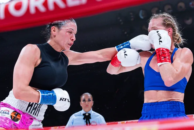 El Paso boxer Stephanie Han throws a punch at Albuquerque boxer Holly Holm during their WBA lightweight world championship bout Saturday, May 30, 2026, at the El Paso County Coliseum in El Paso, Texas.