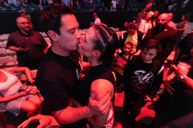 El Paso boxer Stephanie Han kisses her husband, Job Abner Garcia, after defeating Albuquerque boxer Holly Holm to retain her WBA lightweight world championship Saturday, May 30, 2026, at the El Paso County Coliseum in El Paso, Texas.