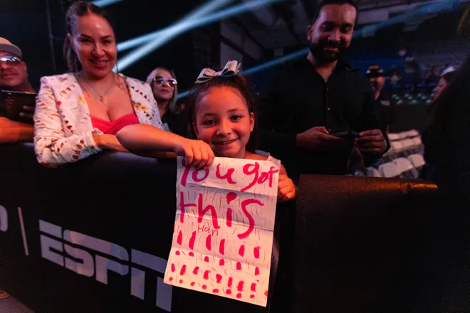 A young fan holds a sign supporting El Paso boxer Stephanie Han after Han defeated Albuquerque boxer Holly Holm to retain her WBA lightweight world championship Saturday, May 30, 2026, at the El Paso County Coliseum in El Paso, Texas.