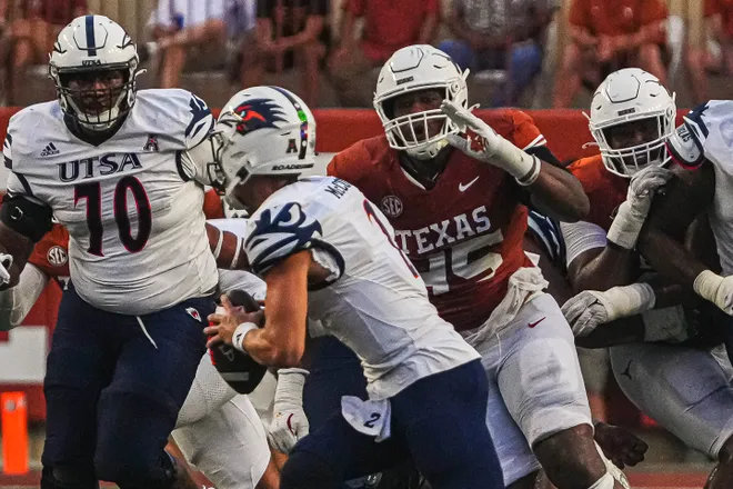 Sep 14, 2024; Austin, Texas, USA; Texas Longhorns defensive lineman Vernon Broughton (45) pressures UTSA quarterback Owen McCown (2) during the game at Darrell K Royal–Texas Memorial Stadium. Mandatory Credit: Aaron E. Martinez/USA TODAY Network via Imagn Images