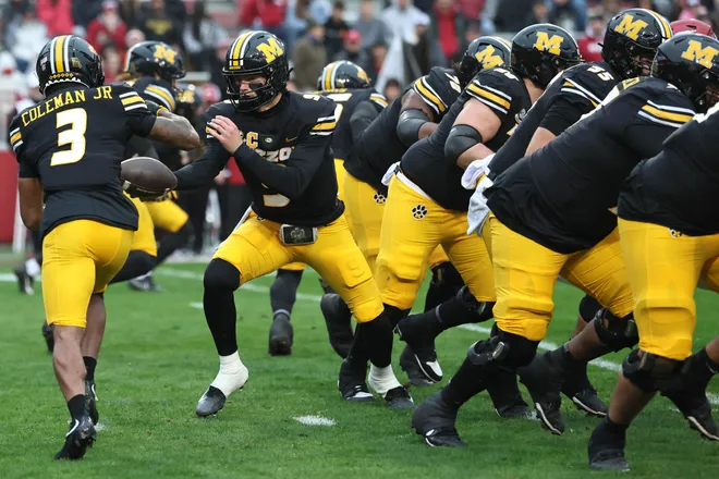 Nov 29, 2025; Fayetteville, Arkansas, USA; Missouri Tigers quarterback Beau Pribula (9) hands off to wide receiver Kevin Coleman Jr (3) during the first quarter against the Arkansas Razorbacks at Donald W. Reynolds Razorback Stadium. Mandatory Credit: Nelson Chenault-Imagn Images