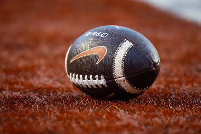 Dec 21, 2024; Austin, Texas, USA; Detailed view of a Nike logo on an official NCAA football during the Clemson Tigers game against the Texas Longhorns in the CFP National playoff first round at Darrell K Royal-Texas Memorial Stadium. Mandatory Credit: Mark J. Rebilas-Imagn Images