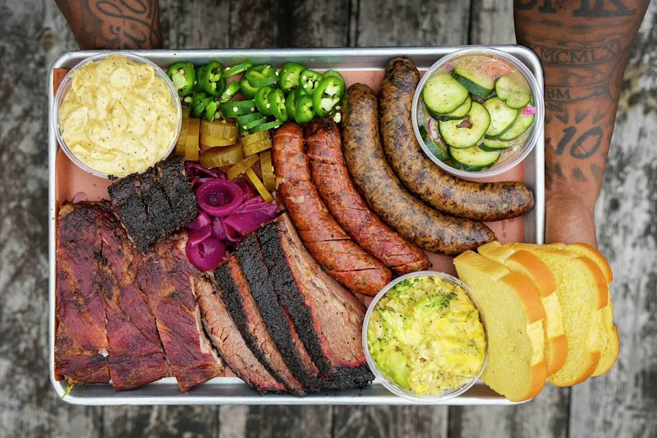 The Texas Trinity platter at Smokey Joe's BBQ comes with brisket, ribs, jalapeño cheddar sausage and sides. (Smiley N. Pool/Staff Photographer)