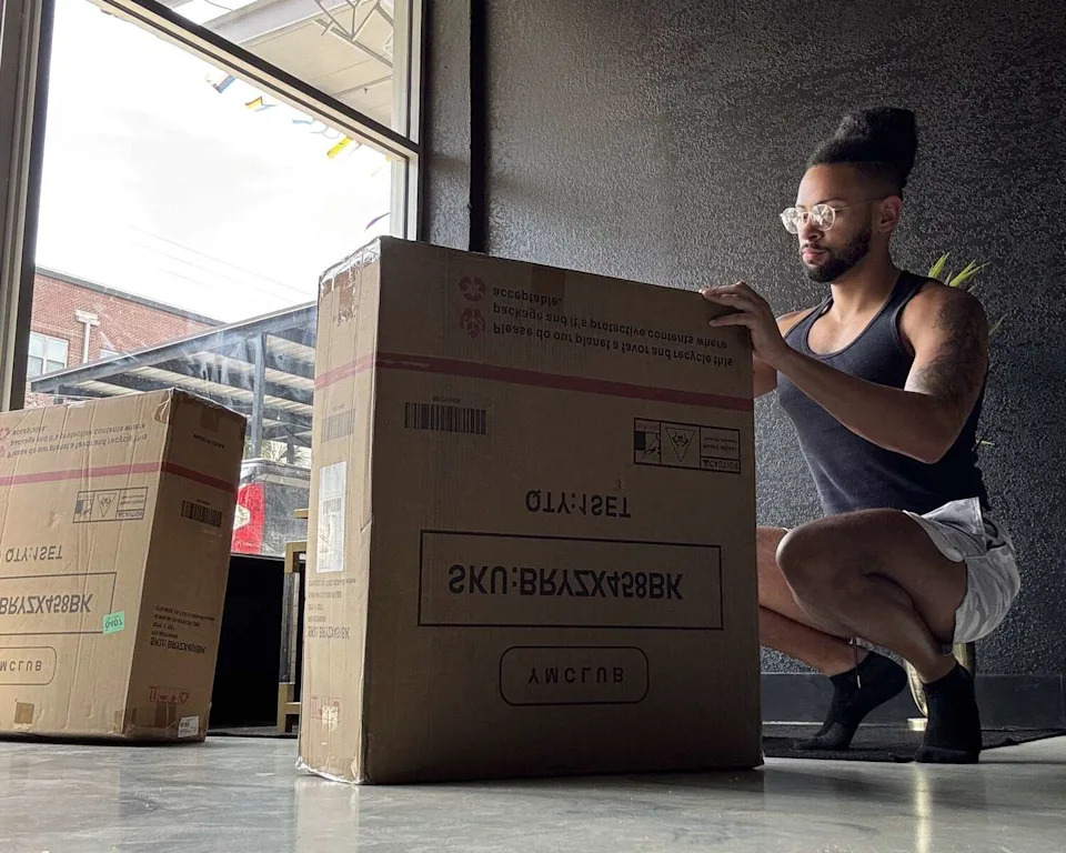 District 2 councilman Jalen McKee-Rodriguez works to set up chairs ahead of Zorra London's Saturday soft opening. (Courtesy Jalen McKee-Rodriguez, Melissa Cabello Havrda, Zorra London Tattoo Studio)
