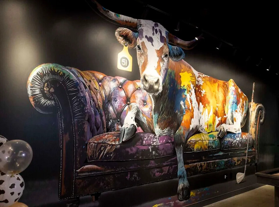 A large mural decorates the inside of Five Iron Golf, which features artwork by local artists.