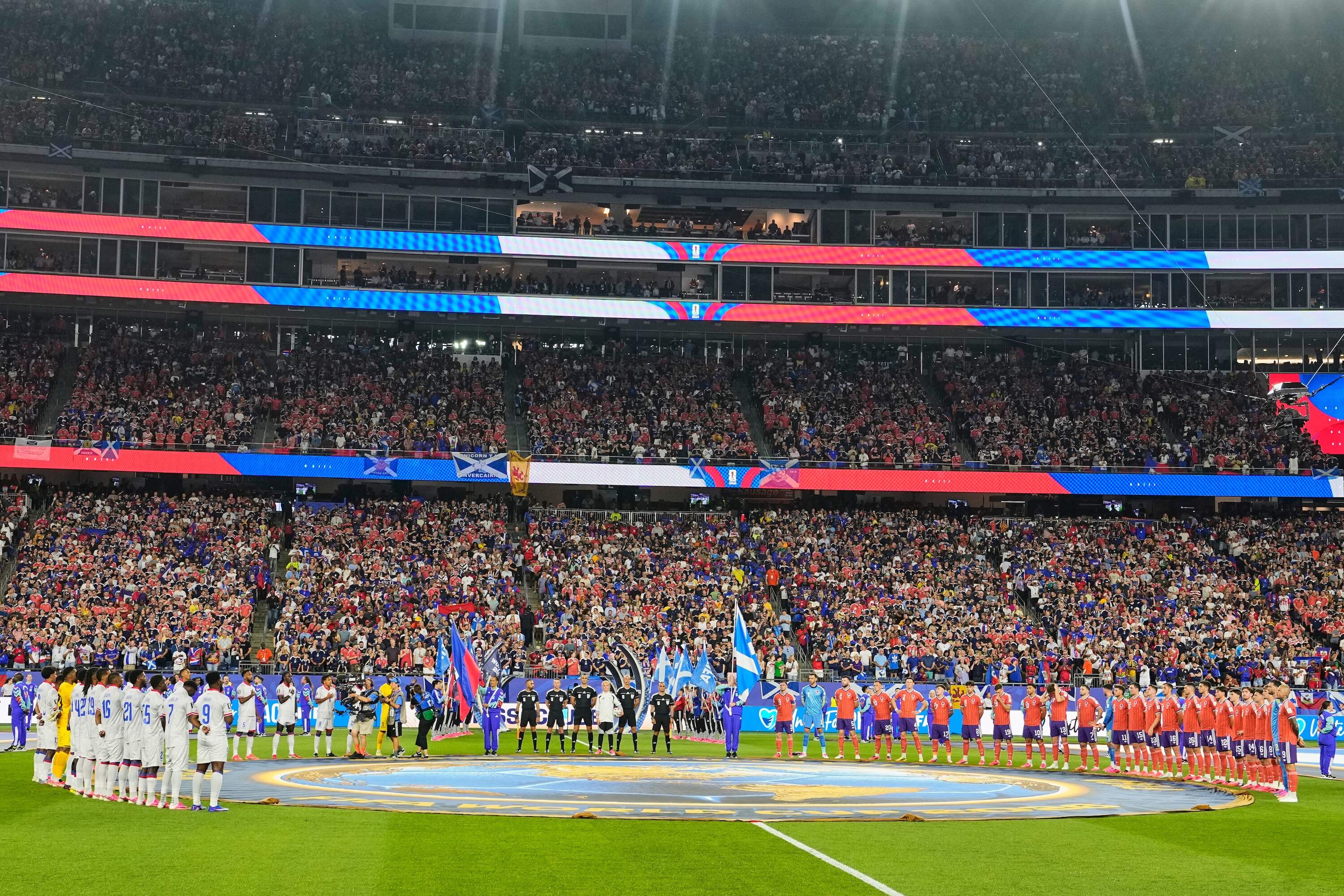 Teams line up for their national anthems ahead of the World Cup Group C soccer match between Haiti and Scotland in Foxborough. (Martin Meissner/AP)