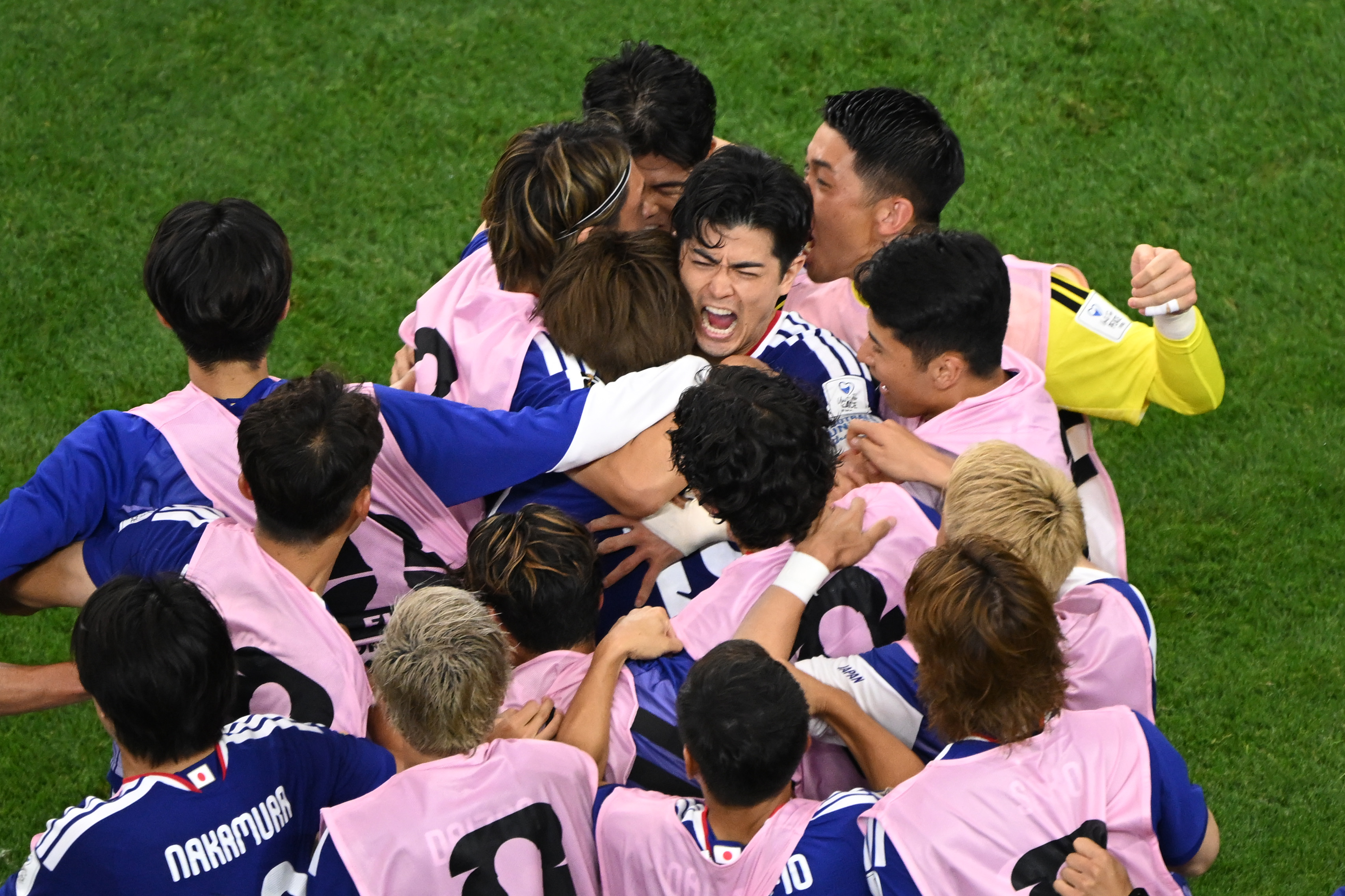 Japan celebrates a goal during the World Cup Group F...