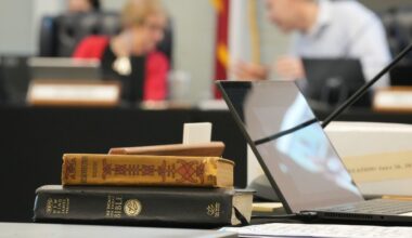 A Bible and Resurrection by Leo Tolstoy sit on the desk of State Board of Education member LJ Francis during a meeting on proposed social studies standards at the Barbara Jordan Building in Austin on Monday, June 22, 2026. (Jay Janner/Austin American-Statesman via AP)