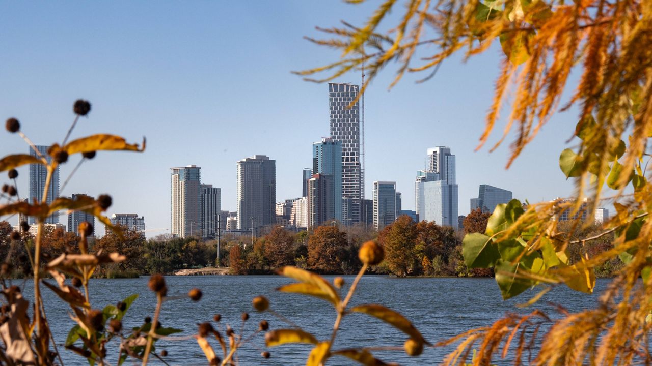 Foliage frames the skyline of downtown Austin, Texas, Dec. 10, 2025. (Mikala Compton/Austin American-Statesman via AP)