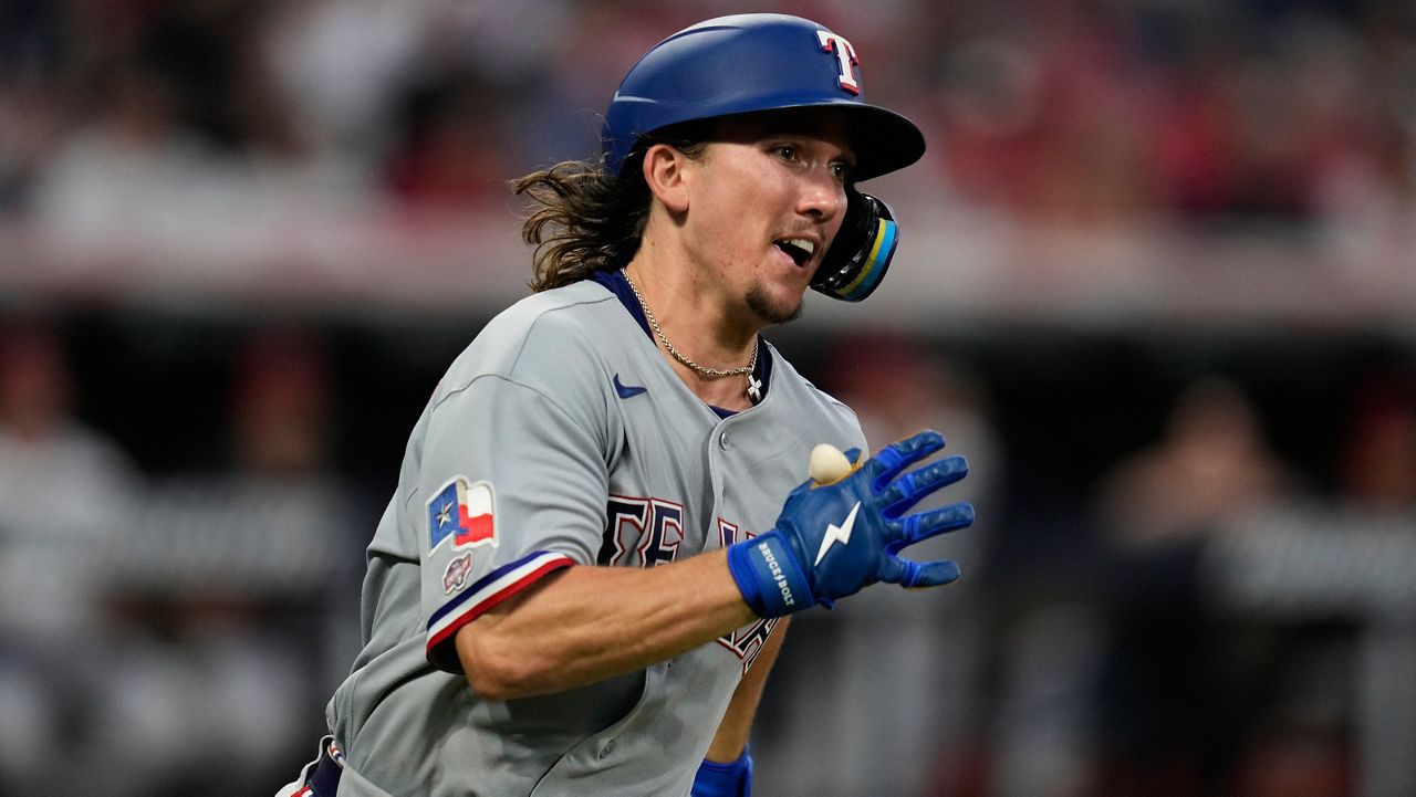Texas Rangers' Cameron Cauley runs towards first base with a triple, his first major league hit, in the seventh inning of a baseball game against the Cleveland Guardians in Cleveland, Monday, June 29, 2026. (AP Photo/Sue Ogrocki)