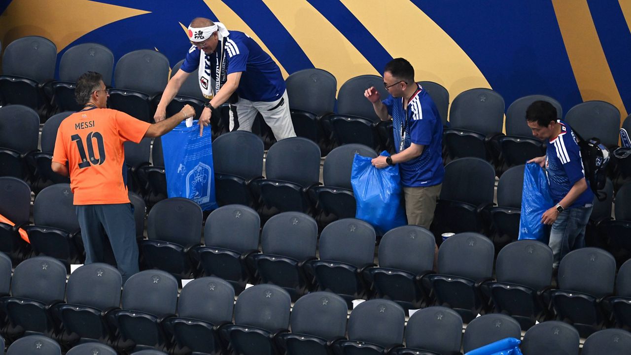 Japan fans clean up trash in the stadium following the World Cup Group F soccer match between the Netherlands and Japan in Arlington, Texas, near Dallas, Sunday, June 14, 2026. (AP Photo/Jessica Tobias)