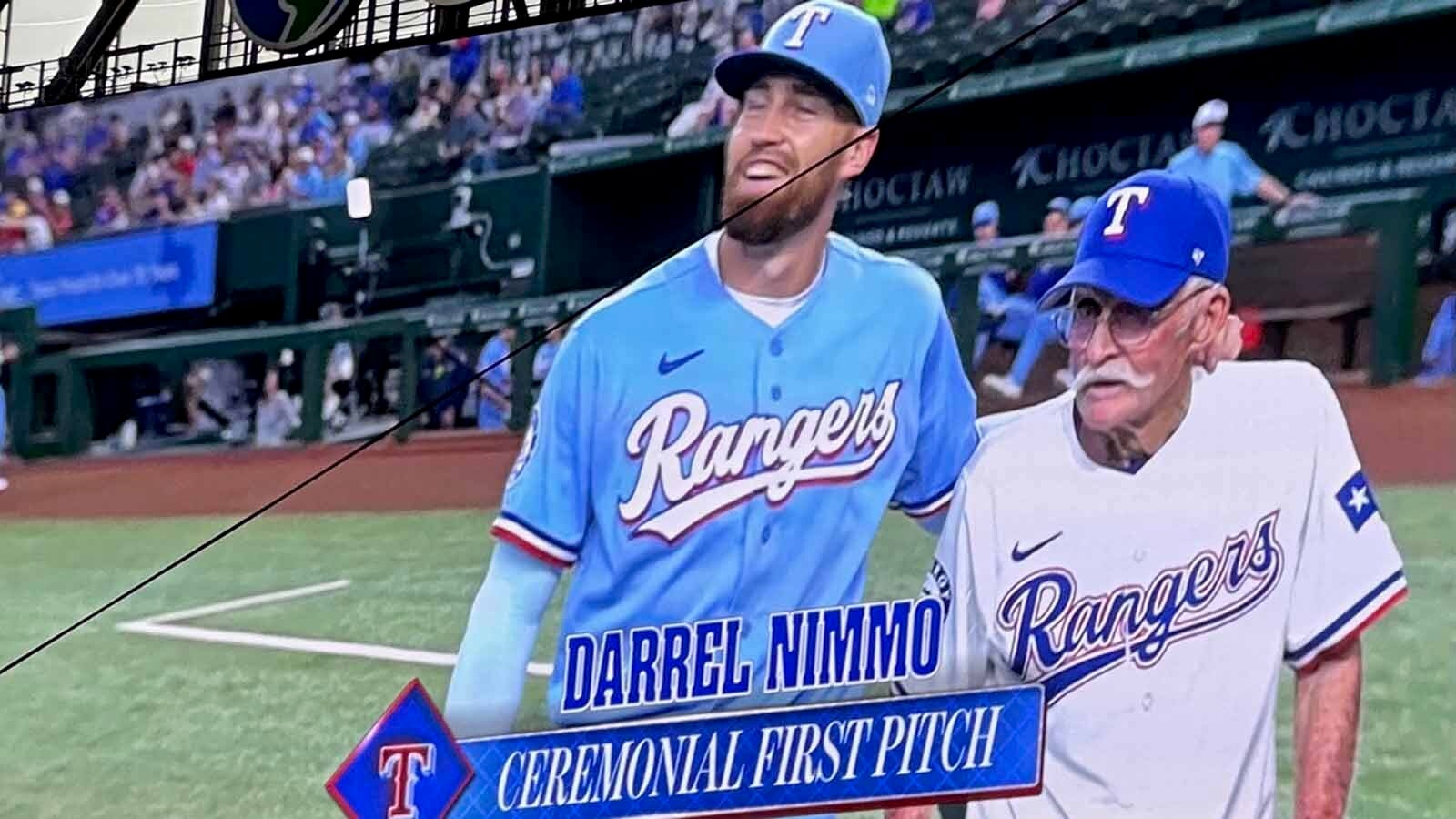 Brandon Nimmo walks off the pitcher's mound with his 90-year old grandpa Darrel Nimmo after Darrel threw out the first pitch.