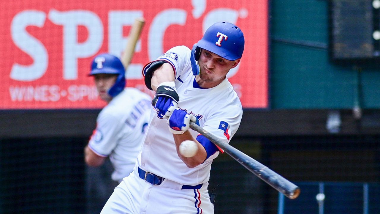Texas Rangers' Corey Seager swings at a pitch during the fourth inning of a baseball game against the St. Louis Cardinals, Saturday, May 31, 2025, in Arlington, Texas. (AP Photo/Ronaldo Bolaños)