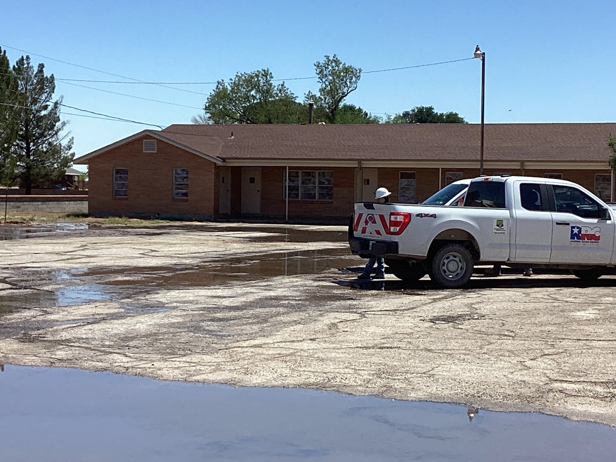 Water pools at the First Baptist Church of Grandfalls on April 21 while a Railroad Commission staff member looks on.
