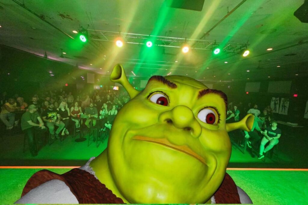 Image shows Shrek face over the set of a Shrek-themed burlesque performance.