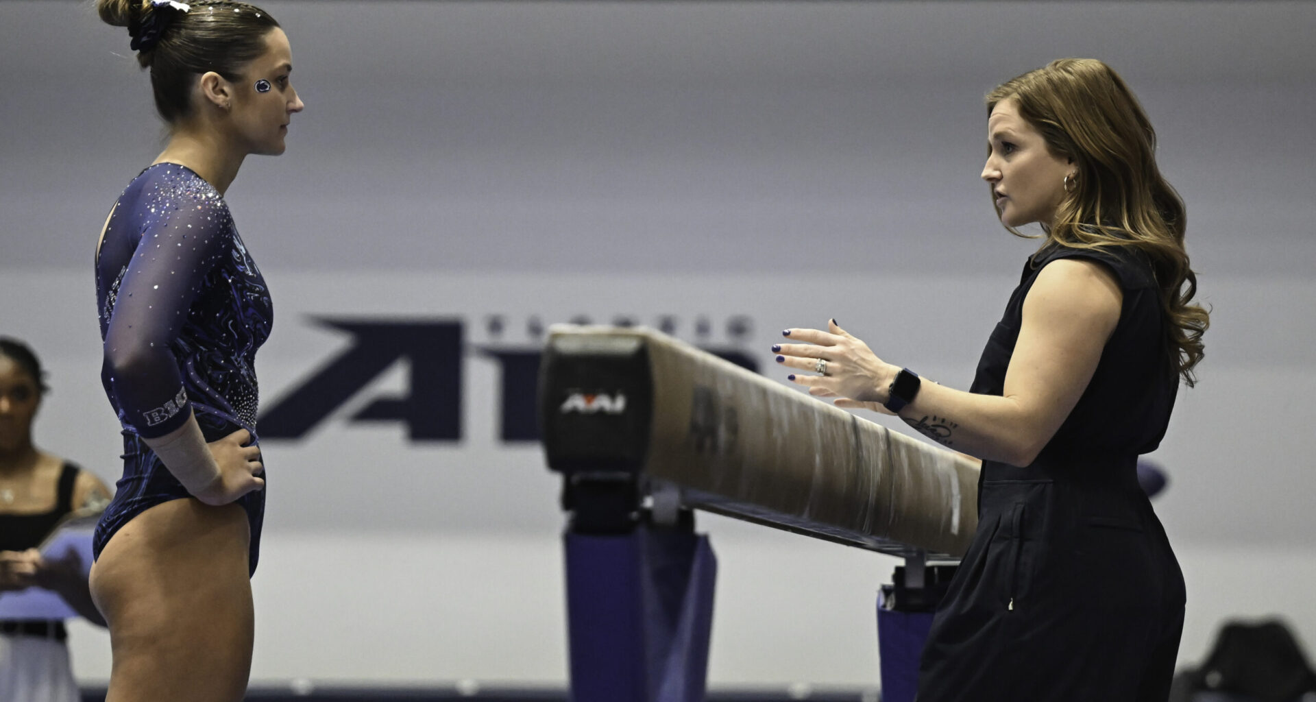 Sarah Brown coaches at a Penn State gymnastics meet.