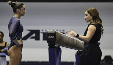 Sarah Brown coaches at a Penn State gymnastics meet.