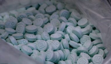 A large bag of seized counterfeit 30 mg Oxy laced with fentanyl is displayed at the Drug Enforcement Administration lab.