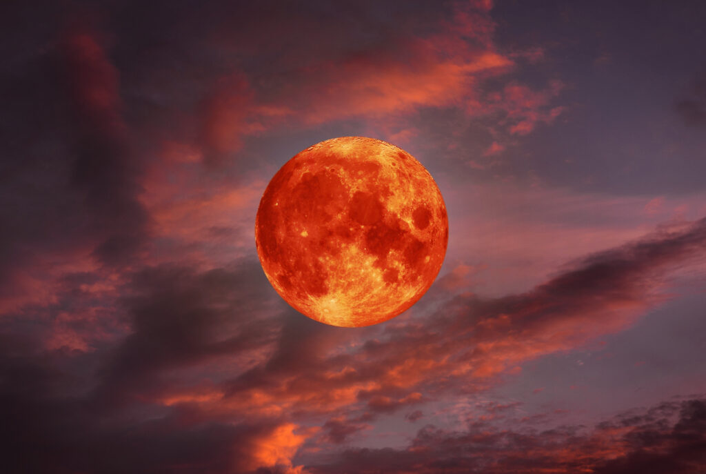 Image shows an artistic rendering of a strawberry moon.