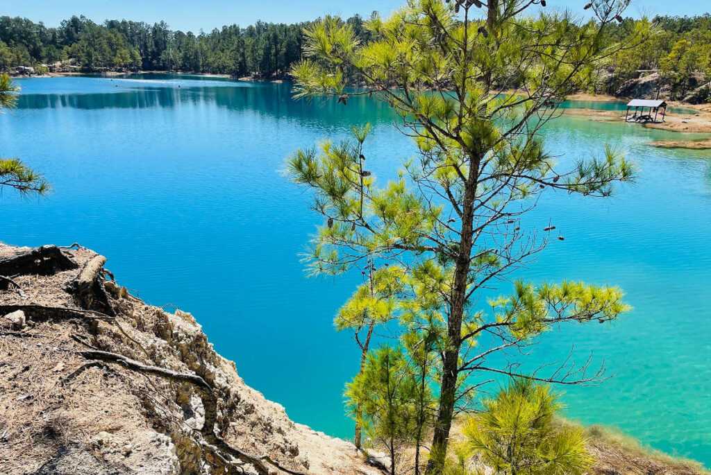 Image shows the Blue Lagoon in Huntsville from the POV of a cliff edge.