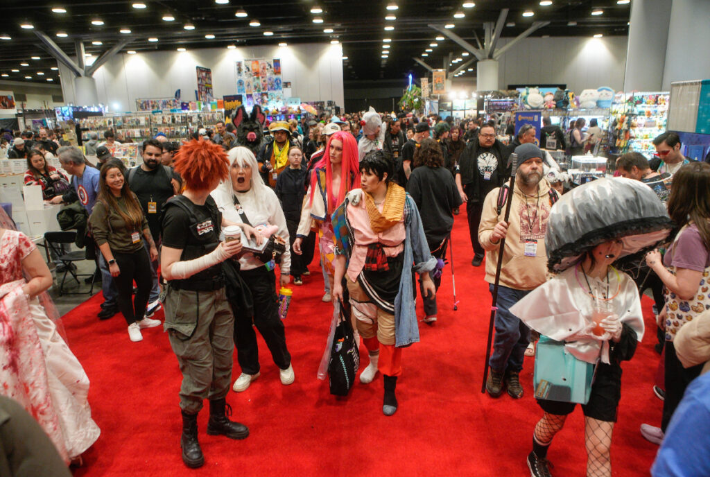 Image shows cosplayers attending an anime convention.