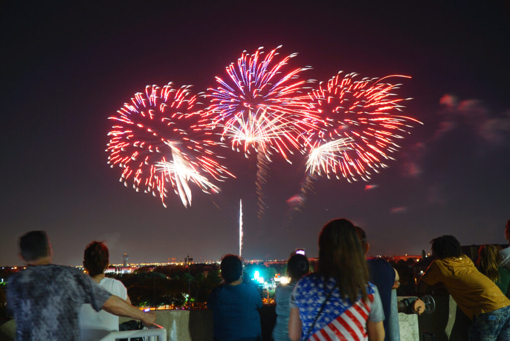 Image shows people watching a fireworks display at Addison Kaboom Town!