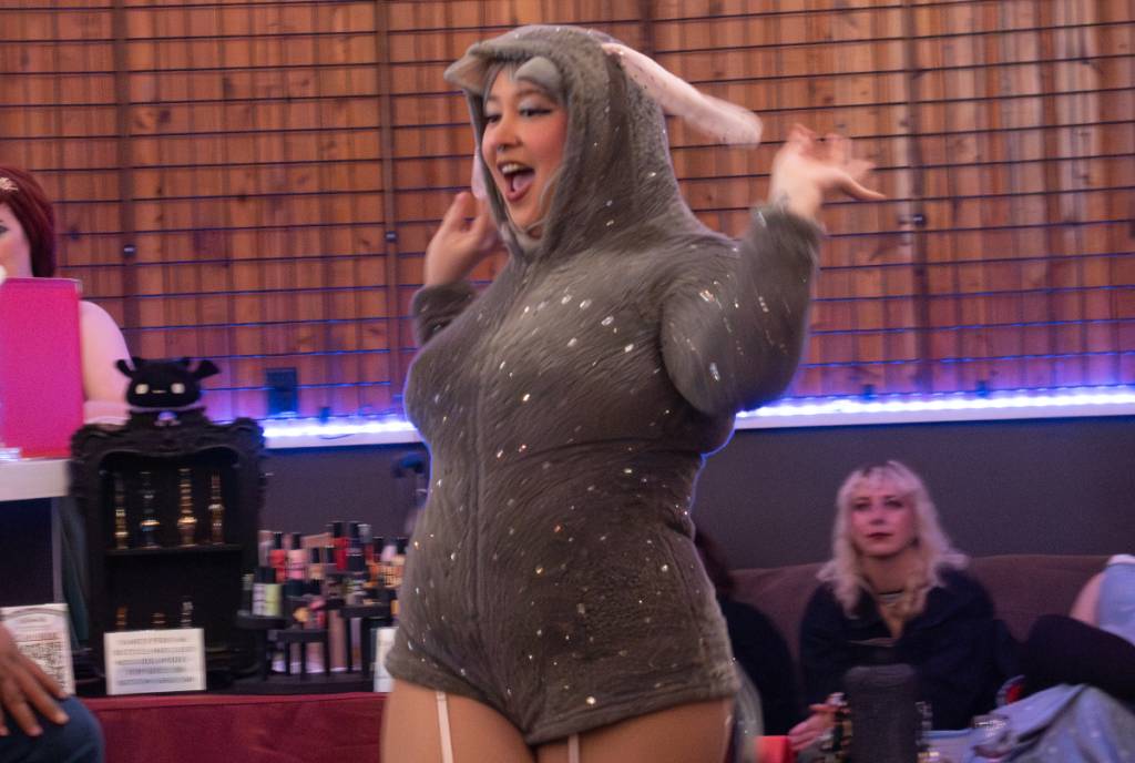 Image shows a burlesque dancer dressed in a "Donkey" costume – inspired by Shrek. 