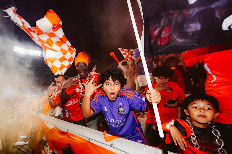 Houston Dynamo supporters celebrate at Shell Energy Stadium, where club executives are betting that World Cup-driven interest can turn the city’s large population of casual soccer fans into long-term customers.