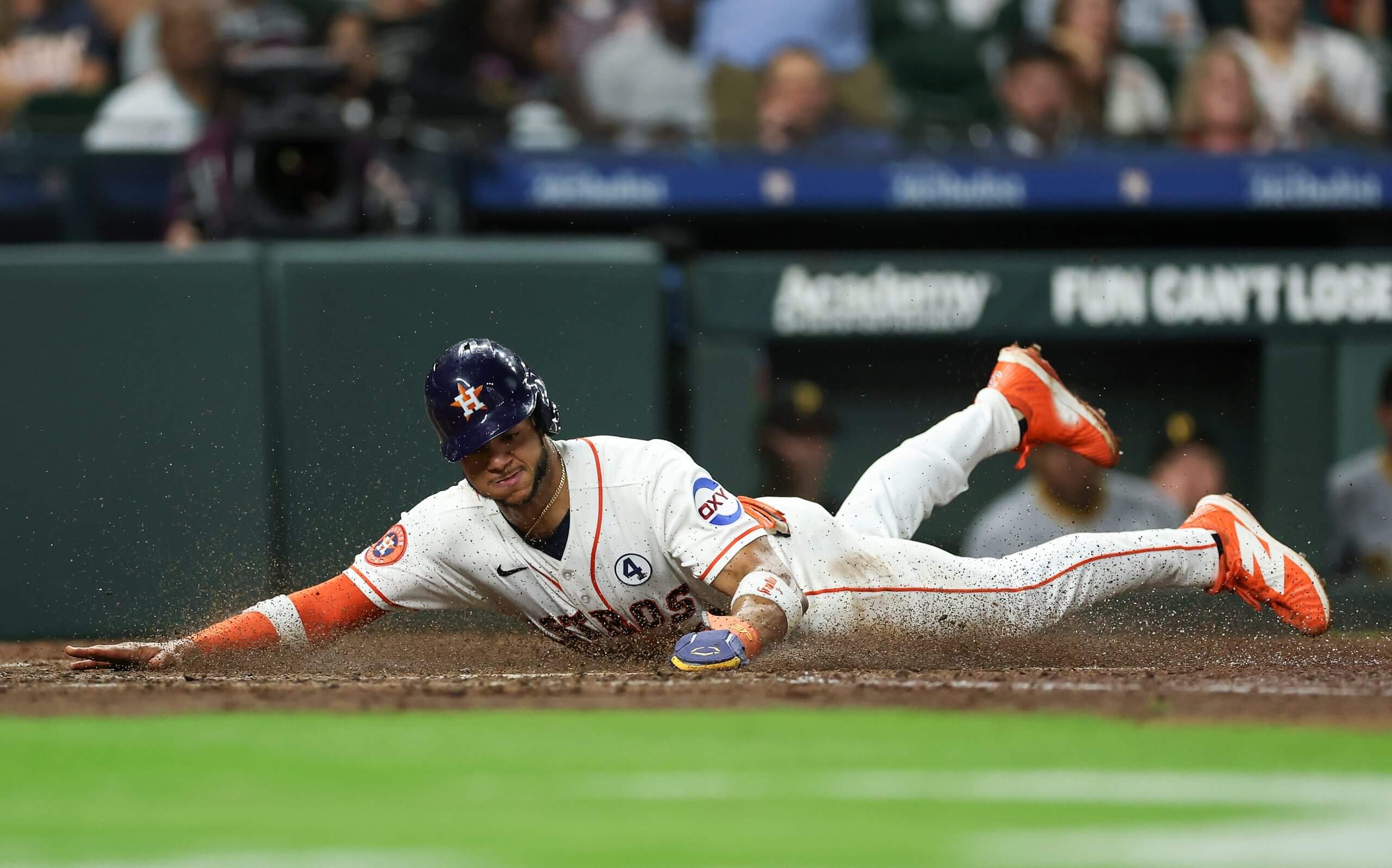 Jeremy Peña slides headfirst while scoring a run at Daikin Park.