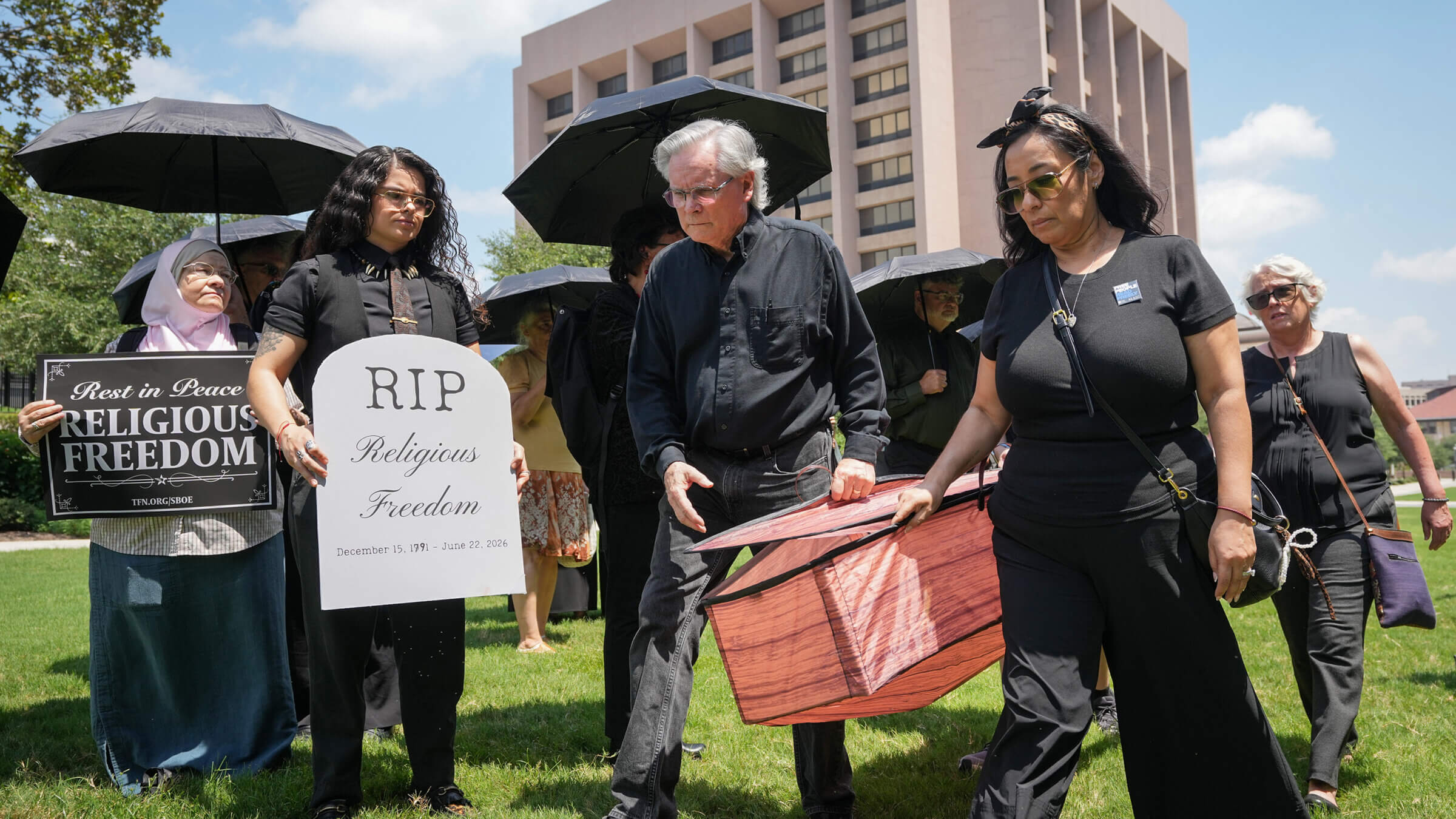 Interfaith protesters held a funeral-themed demonstration for religious freedom outside the building where the Texas State Board of Education voted to require the biblical reading list.