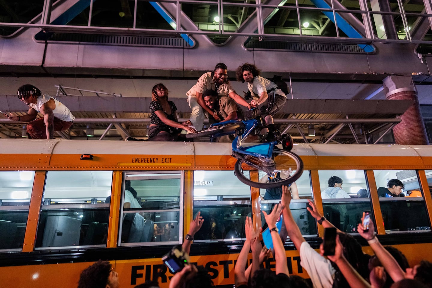 New York Knicks fans pull a citibike on top of a school bus as they celebrate after they win the NBA Finals in Times Square on June 14, 2026 in New York City. The New York Knicks lead the San Antonio Spurs 3-1 and could win the franchise's first NBA championship since 1973 if they win tonight.