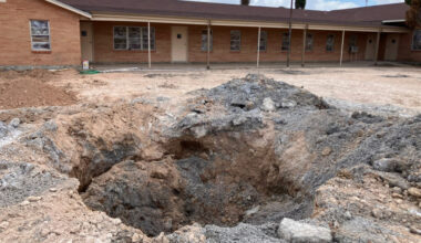 A pit in the parking lot of the First Baptist Church in Grandfalls, Texas, where the Railroad Commission plugged a wellbore that was previously gushing thousands of gallons of wastewater a minute. Credit: Martha Pskowski/Inside Climate News
