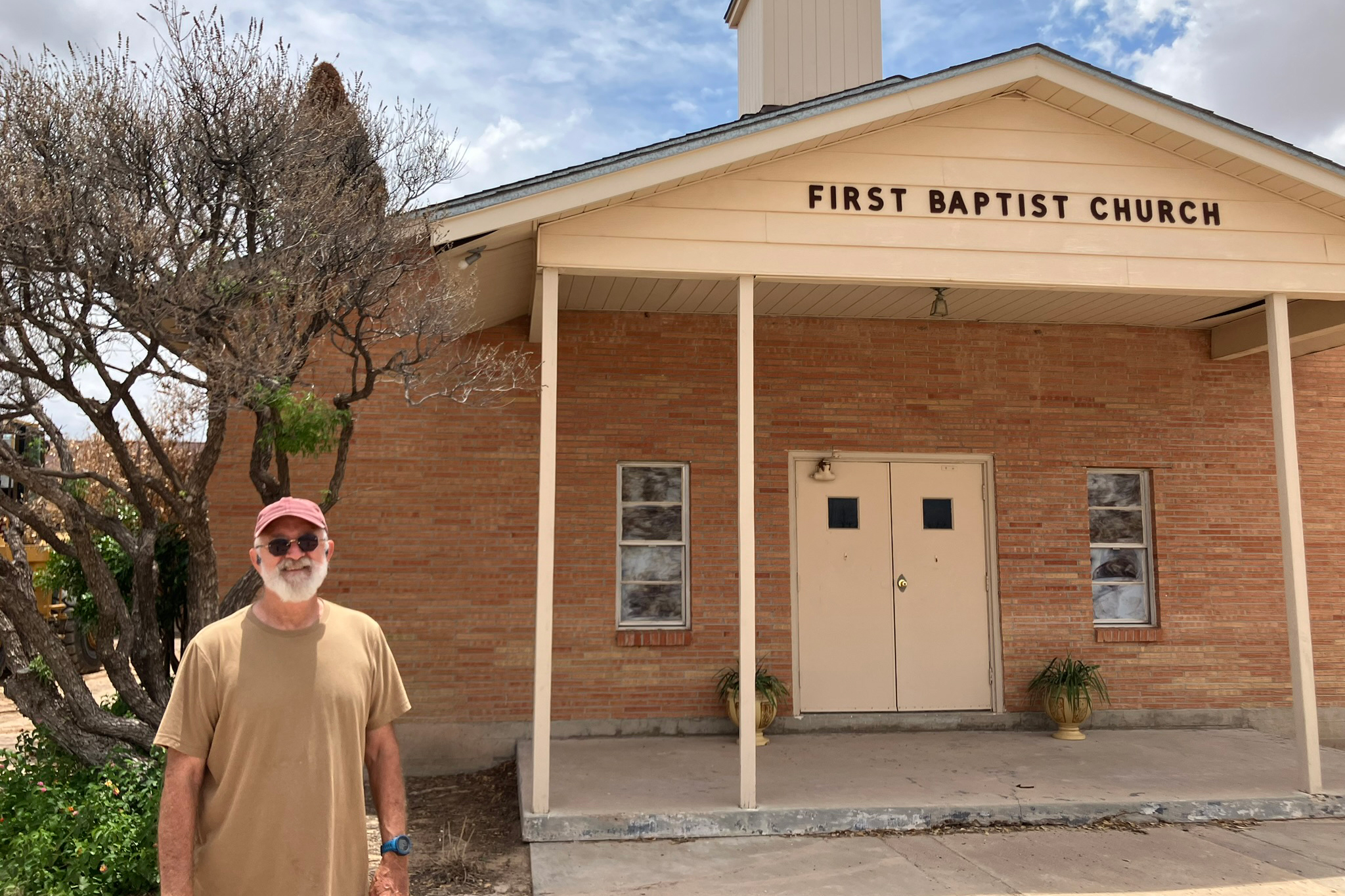 Pastor David Tucker stands outside the First Baptist Church of Grandfalls. Tucker stepped in as pastor at the church last summer in addition to his full-time job in the oil and gas industry. Credit: Martha Pskowski/Inside Climate News