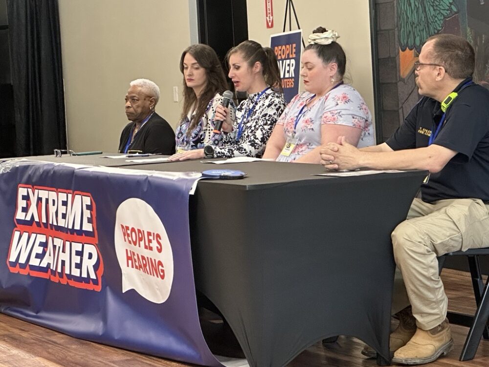 Community members discuss their experiences surviving natural disasters at a town hall on Saturday, May 30, 2026.