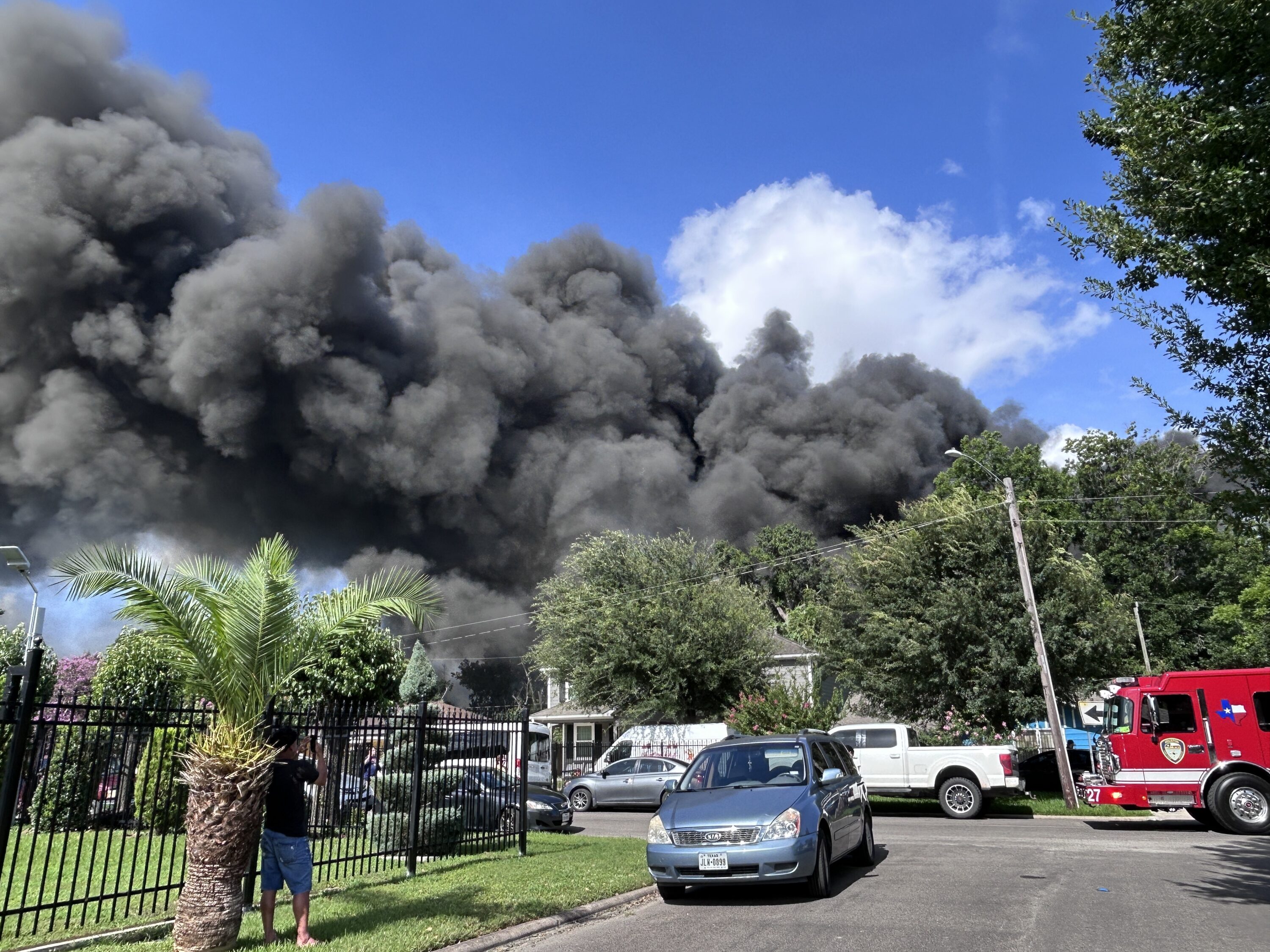 Residents watch the smoke from a nearby tire fire in southeast Houston on June 22, 2026.