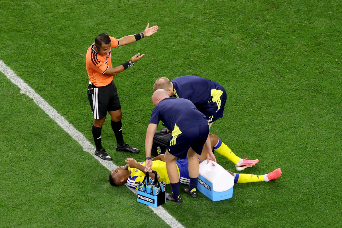 ARLINGTON, TEXAS - JUNE 25: Isak Hien #4 of Sweden receives the medical attention after sustaining an injury during the FIFA World Cup 2026 Group F match between Japan and Sweden at Dallas Stadium on June 25, 2026 in Arlington, Texas. (Photo by Lars Baron/Getty Images)