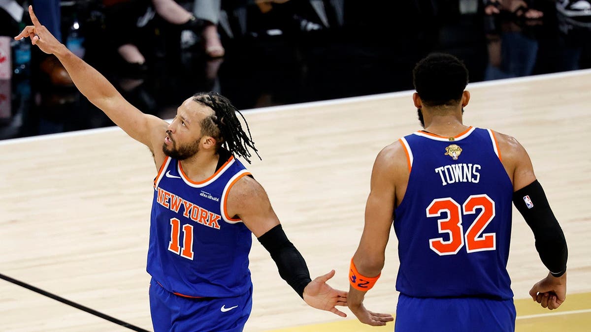 Jalen Brunson celebrating a three-point basket with Karl-Anthony Towns during NBA Finals game