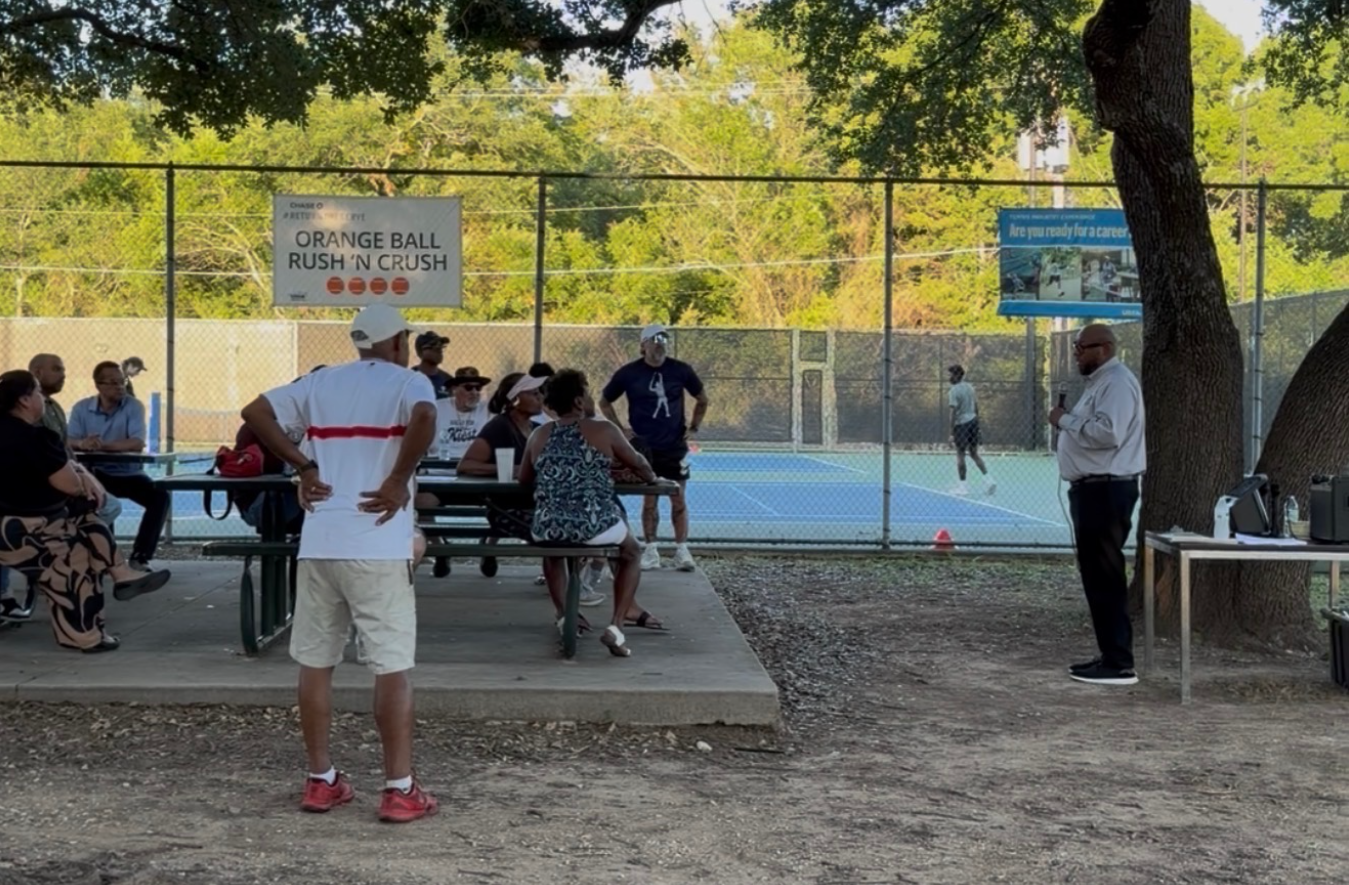 District 4 council member Maxie Johnson addresses community members at a meeting near the tennis courts.