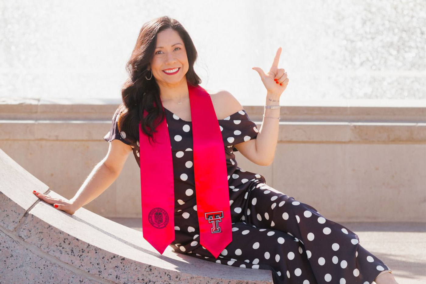 Lesley poses by the Texas Tech seal.