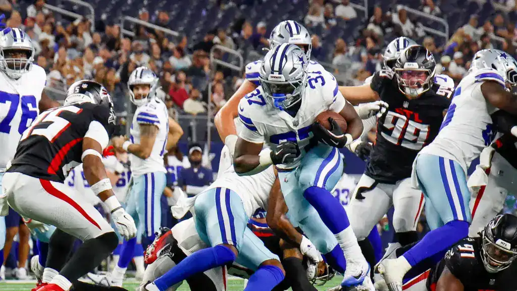 Phil Mafah powers through traffic during Dallas Cowboys preseason action, showcasing the physical running style that has made him one of the team's most intriguing young backs.
